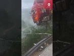 Truck driver's cab hangs over edge of collapsed bridge