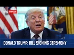 Donald Trump participates in a bill signing ceremony
