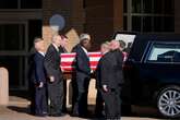 Carter’s casket carried by Secret Service agents as procession begins