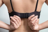 Woman wrongly denied disability benefit for being able to do up bra
