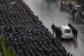 Thousands gather to farewell NYPD officer killed in mass shooting