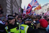 Police search for violent disorder suspects after Tommy Robinson rally