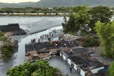 Rescuers wade through mud in Taiwan after Ragasa