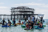 Thousands turn out for paddle out protests over ‘sewage scandal’