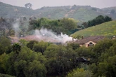 Pilot killed as small plane crashes into homes in California