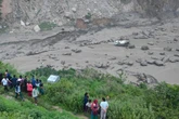 Floods sweep away 18 people and bridge linking Nepal to China