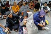 One dead and 65 trapped under rubble after Indonesia school collapse