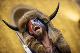 QAnon shaman sues Trump for $40 trillion and takes aim at Elon Musk