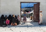 Scores of Syrians return home after years at camp housing people linked to the Islamic State group