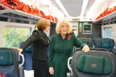 Queen Camilla stuns commuters by riding train for special service