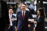 Yoon takes off prison uniform and lies on floor to resist detention