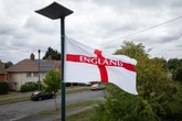 Why are flags being put up in some areas and why is it controversial?