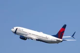 Delta plane was traveling down runway when a jet landed in front of it