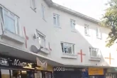 Arrest after woman racially abused and England flags painted on flats