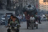 Palestinians flee Gaza City as escalating Israeli offensive kills 77