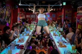 Inside the ‘Muscle Girls’ bar where you can be served by strong women