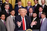 Trump jokes LSU team is ‘ripping’ up his hand from strong shakes