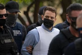 Greek pilot accused of killing British wife jeered as he enters court