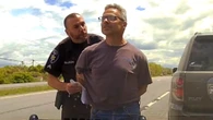 Driver Arrested For Laughing At Cop After Flashing His Lights
