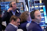 Wall Street holds at its record high even as oil prices climb