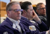Wall Street slides, oil prices again over $100 a barrel as US and Iran trade threats over ports