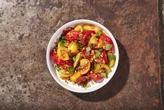 Savory-spicy peanut dressing complements the sweetness of this tomato salad