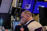 Wall Street ends mixed after the Fed says it's still waiting to see the effects of Trump's tariffs