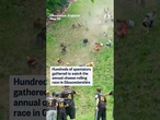 Hundreds of spectators gathered to watch the annual cheese rolling race in Gloucestershire