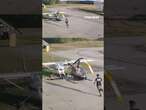 Helicopter spins out of control and crashes into parked plane