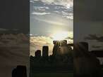 Revelers watch sunset at Stonehenge on summer solstice