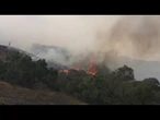Massive wildfires burn out west as Canadian smoke moves east