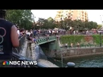 Europe heatwave: Watch Parisians jump into canal during NBC reporter's live shot