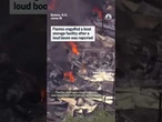 Flames engulfed a boat storage facility after a loud boom was reported