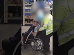 Moment shoplifter pretending to be wheelchair user leaps out to assault security guard