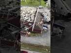 Drone footage shows school bus tossed onto gym from tornado