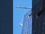 Window washers dangle from broken scaffold in NYC