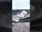 Adventurous man poses with erupting volcano