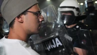 Tear gas fired at thousands of protesters in Serbia demanding free elections and justice