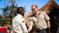 Prince Harry retraces Diana's footsteps by walking through a land mine field in Angola for charity