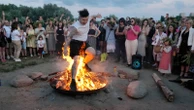 Ukrainians in Warsaw jump over a bonfire, float braids to celebrate solstice custom away from home