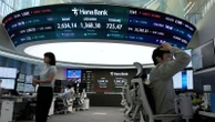 Asian shares mostly lower, trading in a narrow range with US markets closed for Memorial Day