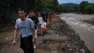 Heavy rain causes flooding, evacuations and at least 38 deaths around Beijing region
