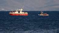 Rescue crews unload body bag in Sicily port as search continues after yacht sinking