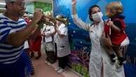 Clowns and musicians bring the joy of Carnival to sick children in a Rio hospital