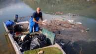 Residents and activists in central Bosnia clean up a lake after massive floods