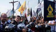 An estimated 180,000 motorcyclists converge at Portuguese shrine to have their helmets blessed.