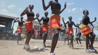 Fusion between culture and modernity as children dance in Kenyan refugee camp
