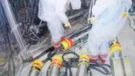 A robot begins removal of melted fuel from the Fukushima nuclear plant. It could take a century