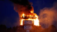 Burning of migrant boat effigy in Northern Ireland triggers police investigation