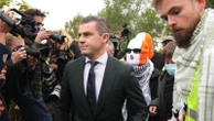 A British court throws out terror-related charge against Irish-language hip-hop group Kneecap member